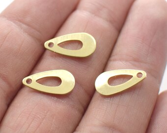 May include: Three gold-colored metal teardrop-shaped charms with a hole at the top. Each charm has a smaller teardrop-shaped cutout in the center.