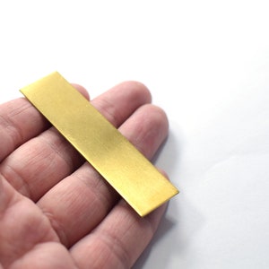 May include: A rectangular piece of brass sheet metal with a brushed finish.