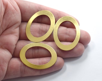 May include: Three gold oval-shaped metal rings. The rings are smooth and have a shiny finish.