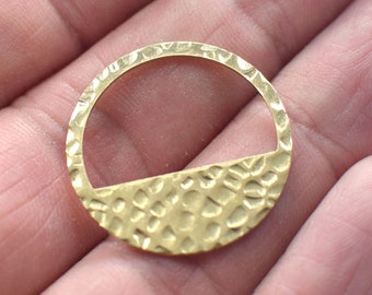 May include: A gold-toned metal ring with a hammered texture. The ring is open on one side, creating a half-circle shape.
