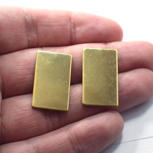 May include: Two gold-colored rectangular metal pieces, possibly for jewelry making or crafting.
