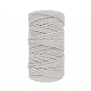 May include: A spool of natural white cotton rope, ideal for crafting and macrame projects.