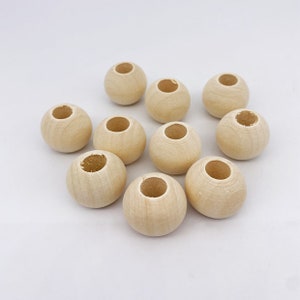 Lot of wooden beads of different diameters, for DIY, creative hobbies and macrame