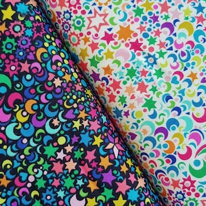 May include: Two fabric swatches featuring a colourful pattern of stars, moons and swirls. One swatch is black with a bright neon pattern, and the other is white with a pastel pattern.