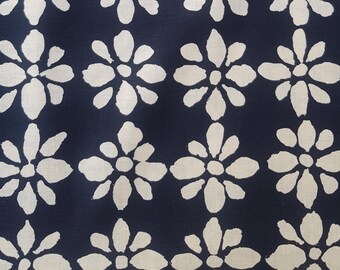 May include: A navy blue fabric with a white floral pattern. The flowers are stylised and have a slightly distressed look.