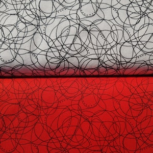 May include: Two pieces of fabric with a black and white scribble pattern. The top piece is white with black scribbles and the bottom piece is red with black scribbles.