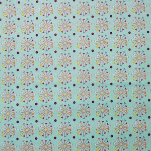 May include: A turquoise fabric with a repeating pattern of colorful Ferris wheels and dark purple polka dots.