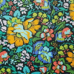 May include: A colorful floral print fabric with a dark background. The fabric features a variety of flowers in shades of blue, yellow, orange, pink, and green.