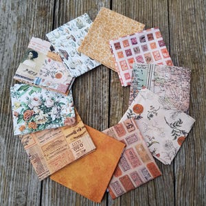 May include: A collection of 10 fabric squares with various patterns and colors, including floral, vintage, and geometric designs. The fabric squares are arranged in a circle on a wooden surface.