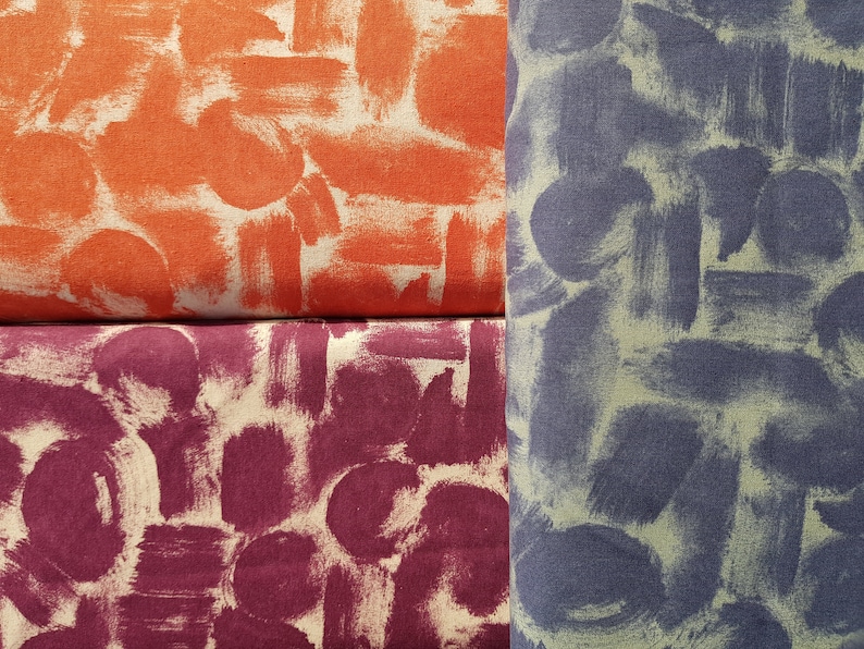 May include: Three fabric swatches with a brushstroke pattern. The top swatch is orange, the middle swatch is burgundy, and the bottom swatch is a dark blue.