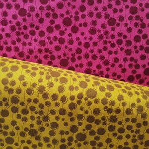 May include: Two fabric swatches with a repeating pattern of brown circles connected by thin lines on a yellow and pink background.