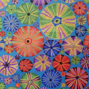May include: A colourful fabric with a repeating pattern of sea urchins. The sea urchins are in various colours, including red, green, blue, yellow, and purple. The background is a light blue colour.