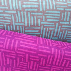 May include: Two fabric swatches with a geometric pattern of thin lines. The top swatch is teal blue and brown, and the bottom swatch is a deep magenta.