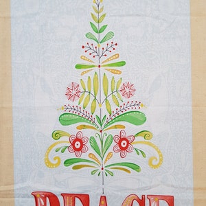 May include: A white fabric with a stylized floral design in shades of green, yellow, and red. The design resembles a Christmas tree with the word "PEACE" written in red letters with yellow and pink accents.