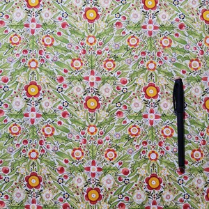 May include: A green fabric with a repeating pattern of red, yellow, and white flowers. The fabric has a white background and is covered in a dense floral pattern.
