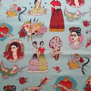 May include: Light blue fabric featuring Frida Kahlo illustrations in a tattoo style. The design includes portraits, hearts, flowers, swallows, arrows, and text in Spanish. The overall aesthetic is a blend of art and cultural motifs.