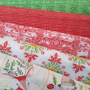 May include: Four different fabric swatches with a Christmas theme. The top swatch is a green fabric with a white polka dot pattern. The second swatch is a red fabric with a white polka dot pattern. The third swatch is a white fabric with a red and white floral pattern. The bottom swatch is a white fabric with a red and green floral pattern and a reindeer illustration.