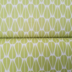 May include: Two pieces of fabric with a repeating pattern of green teardrop shapes on a white background.