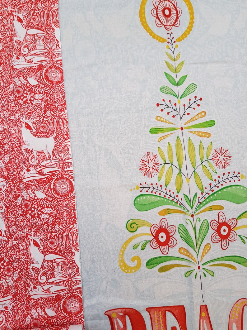 May include: Red and white fabric with a repeating pattern of stylized deer, birds, and floral designs. The fabric is next to a white fabric with a stylized green and yellow tree with red flowers and the word "PEACE" in red.