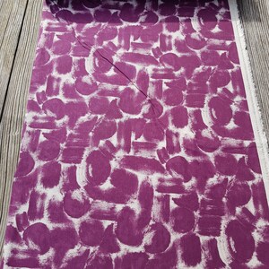 May include: Purple fabric with a white abstract brushstroke pattern. The fabric is folded in half and the pattern is visible on both sides.