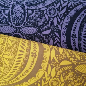 May include: Two fabric swatches with a repeating pattern of stylized flowers and leaves. The top swatch is a dark purple and black fabric. The bottom swatch is a yellow and brown fabric.