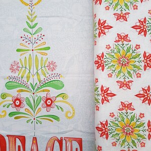 May include: White fabric with a red and green stylized Christmas tree design and the word "PEACE" in red and pink letters. The fabric is next to a white fabric with a repeating pattern of red and green stylized flowers.