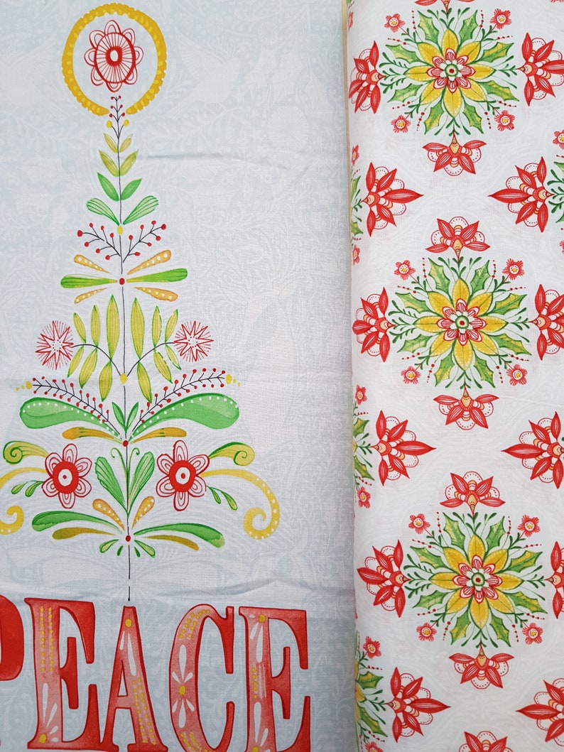 May include: White fabric with a red and green stylized Christmas tree design and the word "PEACE" in red and pink letters. The fabric is next to a white fabric with a repeating pattern of red and green stylized flowers.