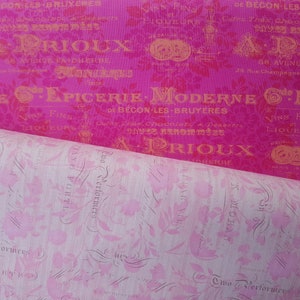 May include: A close-up of pink and white patterned fabric with gold lettering. The text reads "A Prioux 68 Avenue Faidherbe 26 Rue Champagne" and "Epicerie Moderne de Bécon-les-Bruyères".