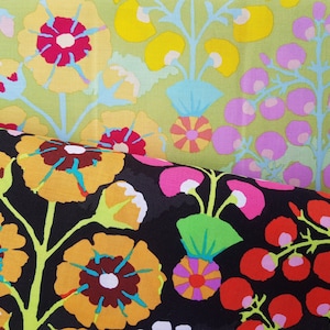 May include: Two fabric swatches featuring floral patterns. The top swatch is light green with yellow and pink flowers. The bottom swatch is black with yellow, red, and pink flowers.