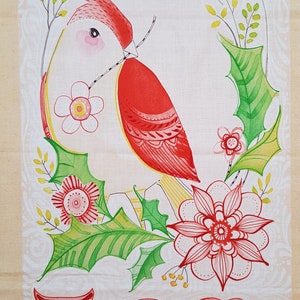 May include: A red cardinal bird with a yellow beak and white belly is perched on a branch with green leaves and red flowers. The word "JOY" is written in red and yellow letters below the bird.