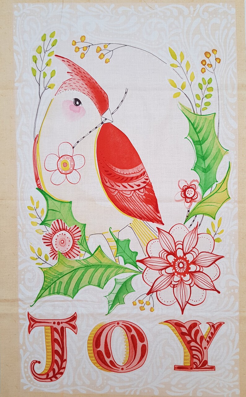 May include: A red cardinal bird with a yellow beak and white belly is perched on a branch with green leaves and red flowers. The word "JOY" is written in red and yellow letters below the bird.
