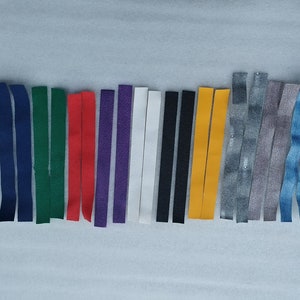 May include: A collection of 15 different colored leather strips, each approximately 10 inches long. The colors include blue, navy, green, red, purple, white, black, yellow, gray, and denim.