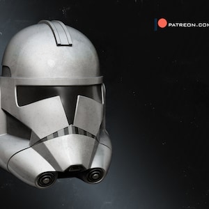 May include: A white, plastic clone trooper helmet with a black visor. The helmet has a textured surface and is designed to look like a real helmet.