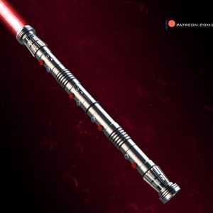 May include: A silver lightsaber with a red blade. The lightsaber has a textured handle with red accents.