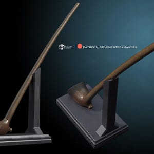 May include: Two long, brown wooden pipes on black stands. The pipes are curved and have a bowl at one end. The stands are simple and have a rectangular base.