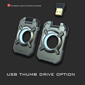 May include: Two silver USB thumb drives with a circular design and the text "GTNO453.0" on each. The thumb drives are on a black background.
