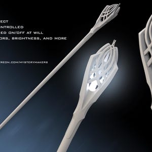 May include: A white staff with a decorative top, featuring a light-up effect. The staff is remotely controlled and can change colours and brightness. Text on the image includes "LIGHT-UP EFFECT", "REMOTELY CONTROLLED", and "PATREON.COM/MYSTERYMAKERS".