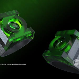 May include: Two Green Lantern rings with a transparent green design and a silver base. The rings are set against a dark green and black background. The rings have a circular emblem in the center.