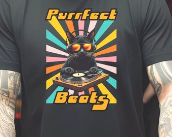 May include: A black t-shirt with a retro-style graphic of a cat wearing sunglasses and headphones, spinning a record on a turntable. The graphic is surrounded by colorful rays and the text "Purrfect Beats".