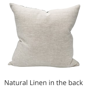 May include: A beige linen pillow with a black border. The back of the pillow is made of natural linen.