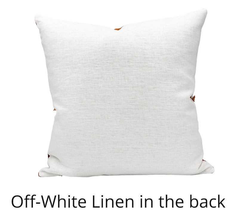 May include: Off-white linen pillow with a brown accent. The pillow is shown from the back.