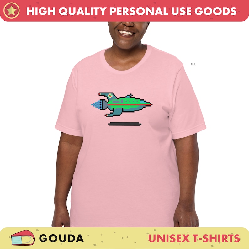 May include: A pink unisex t-shirt with a pixelated image of a spaceship. The text "HIGH QUALITY PERSONAL USE GOODS" is at the top of the image. The text "GOUDA" is at the bottom left of the image. The text "UNISEX T-SHIRTS" is at the bottom right of the image.