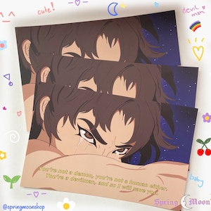 May include: A print featuring a stylized illustration of a person with brown hair and dark eyes. The person is crying and the background is a dark blue with stars. The text "You're not a demon, you're not a human either. You're a devilman, and so I will save you." is printed in yellow on the bottom of the print. The text "Spring Moon" is printed in white on the bottom right corner of the print.