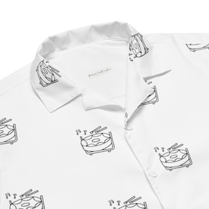 May include: White button-up shirt with a black and white illustration of a steel drum with drumsticks and musical notes repeated throughout the fabric.
