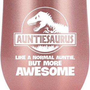May include: A rose gold stainless steel wine tumbler with a white dinosaur graphic and the text "Auntiesaurus Like a normal auntie, but more awesome".