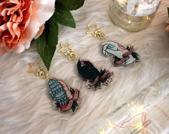 May include: Four keychains with gold star-shaped charms and different hand designs. Each keychain features a hand with a different color and design, and a ribbon with a quote. The quotes are "Give it all you've got", "Let a thousand flowers bloom", "Give it all you've got", and "Let a thousand flowers bloom".