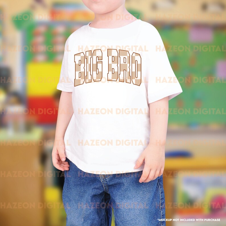 May include: White t-shirt with a brown and white checkered design that says "BIG BRO" in brown letters.