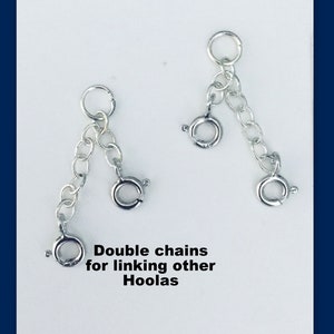 May include: Two silver double chains for linking other items. The chains have a jump ring at each end and are designed for attaching to other jewelry pieces.