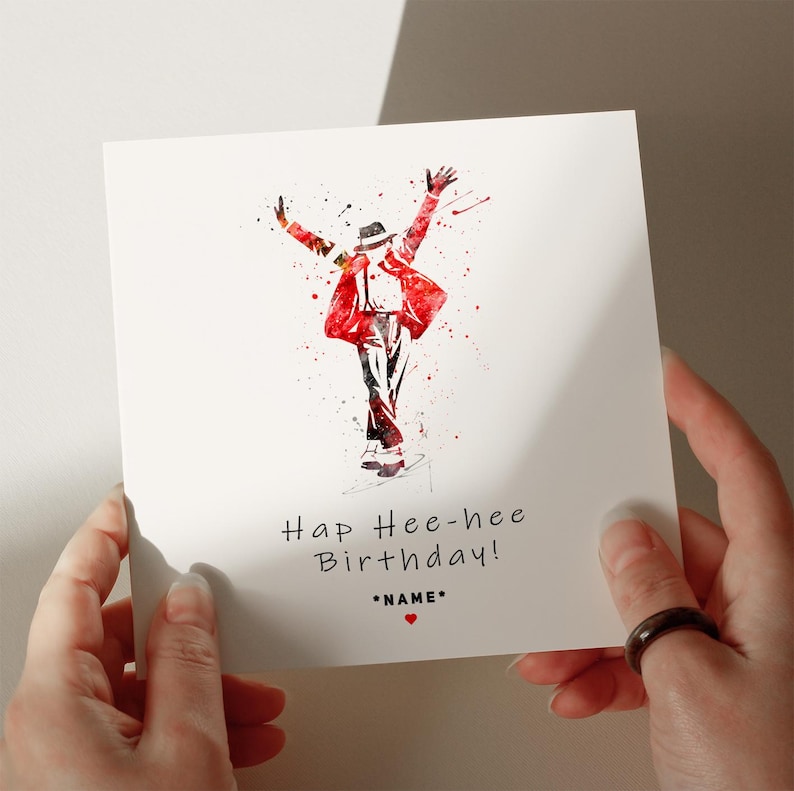 a person holding up a card with a painting of a man in a red jacket