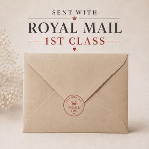 a brown envelope with a stamp and text, sitting on a surface.